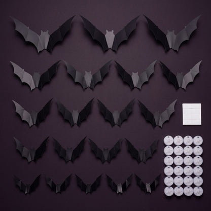 GALLERY. Flat lay of the GlowBats pack contents, matte black bats in five sizes with round LED pucks and adhesive pads